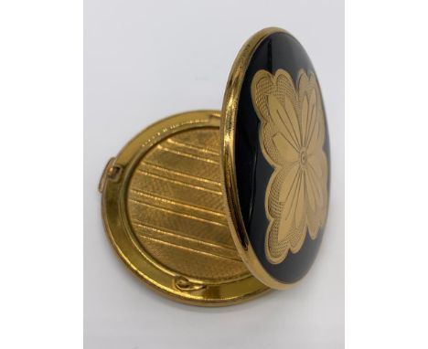 Vintage 1950/60's compact by Melissa. Black enamel lid with gold feature engine turned base. 