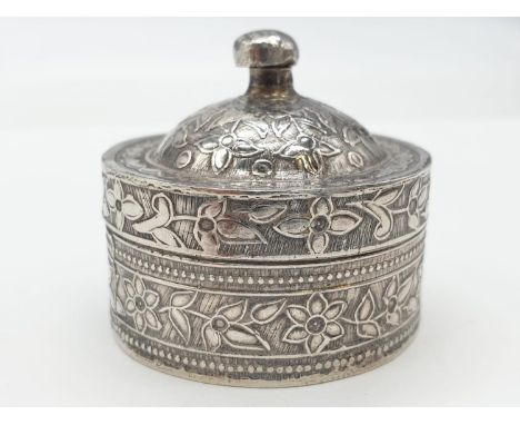 Vintage silver snuff / pill box. Circular form having snug fitting lid with finial. Raised chase work to box and lid. Contine