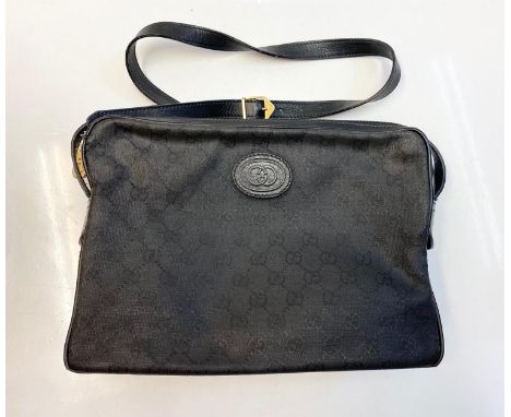 Vintage Gucci styled black canvas messenger bag. 2 side compartments with interior zipped pocket. Leather strap. Bag measures