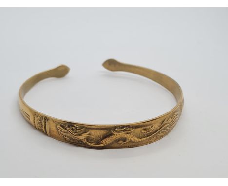 Vintage yellow metal bangle, believed to be oriental with dragon motif. 14.5g. 