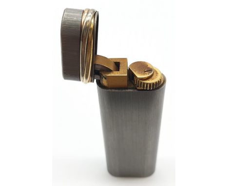 Cartier brushed silver style with two coloured gold trim lighter, full working order. 
