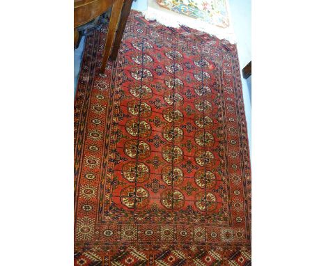 Tekke rug with three rows of nine gols on a wine ground with borders, together with another Turkoman prayer rug (cut and worn