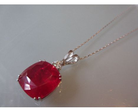 Large 18ct white gold treated ruby and diamond pendant on an 18ct white gold chain, the treated cushion cut ruby approximatel
