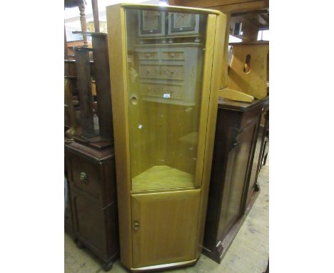 Modern Ercol standing corner cabinet with glazed upper section and panelled door