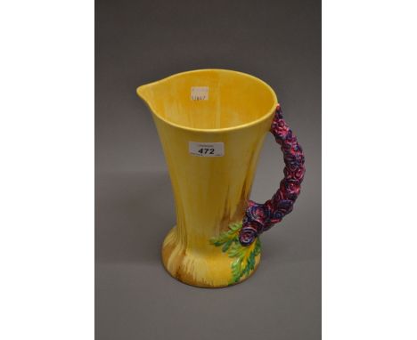 Clarice Cliff Bizarre jug decorated with a mottled glaze in beige and brown with a floral design handle, 9ins high