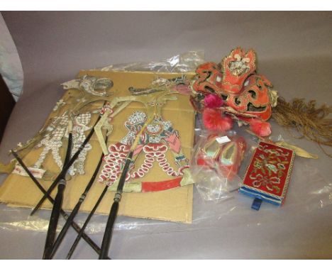 Asian silk gilded headdress, pair of silk floral embroidered child's slippers, similar purse and a shadow puppet