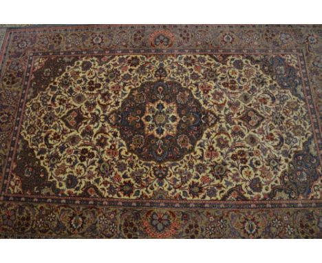 Kirman rug with medallion and all-over floral design on an ivory ground with corner designs and borders, 7ft x 4ft approximat