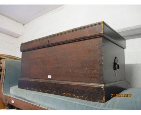 19th Century stained pine trunk with hinged lid above a plinth base