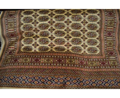 Beige ground Bokhara pattern machine rug, 1.9m x 1.4m
