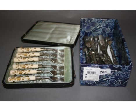 Cased set of six silver plated and ceramic pastry forks together with a set of six plated dessert knives and forks
