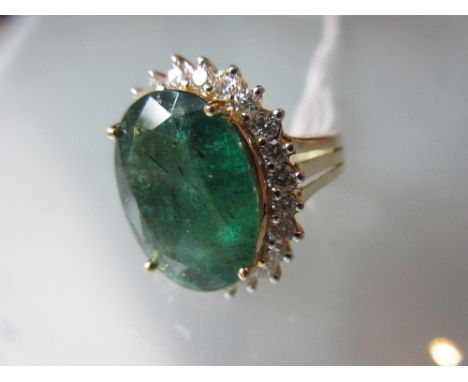 Large 18ct yellow gold oval emerald and diamond cluster ring, the emerald approximately 8.9ct, the diamonds approximately 0.8