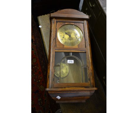 Reproduction rectangular cased wall clock with a brass dial and three train movement together with an early 20th Century oak 