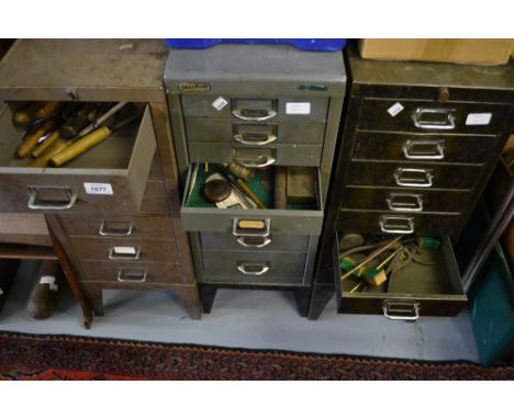 Three 20th Century metal machinists cabinets containing a large quantity of various tools and clock finials, watchmakers part