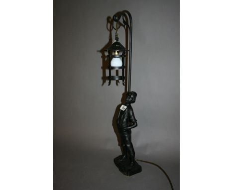 Spelter table lamp in the form of a whistling boy under a lantern (painted black), 26ins high