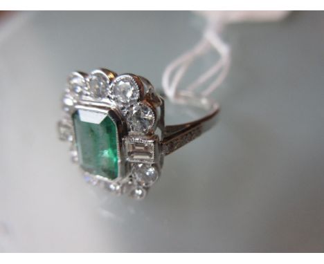 White gold rectangular emerald baguette and brilliant cut diamond cluster ring