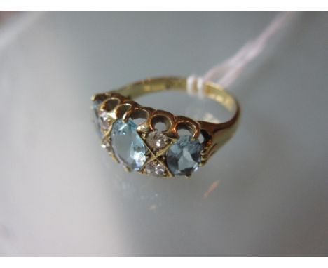 Yellow gold ring set three oval aquamarine and four diamonds