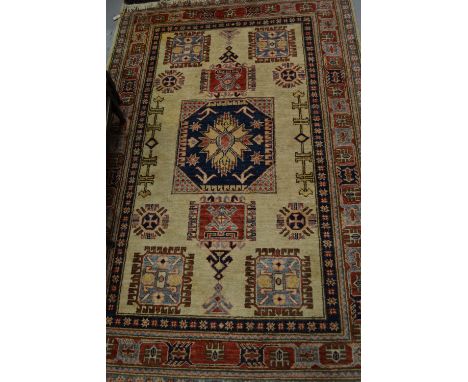 Afghan Caucasion rug with multiple medallions and borders on a beige ground, 5ft 9ins x 3ft 9ins