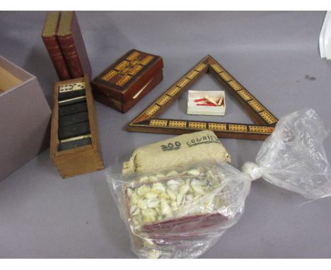 Two inlaid cribbage boards, quantity of bone and ebony dominoes and a large quantity of cowrie shells