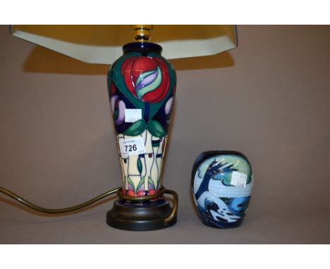 Moorcroft baluster form lamp base of stylised floral decoration with cream and blue trimmed shade together with a small Moorc