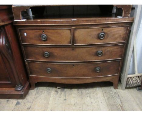 19th Century mahogany bow fronted chest of two short and two long drawers with circular brass ring handles raised on splay fe