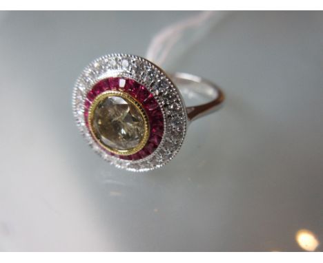 18ct White gold ruby and diamond target ring, the central brilliant cut diamond approximately 1.1ct