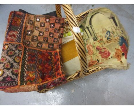 Basket containing a quantity of various textiles including a small tapestry ' The Last Supper ', a machine woven curtain pelm