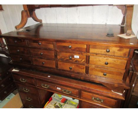 Reproduction mahogany rectangular trunk form coffee table with a hinged top above multiple small drawers