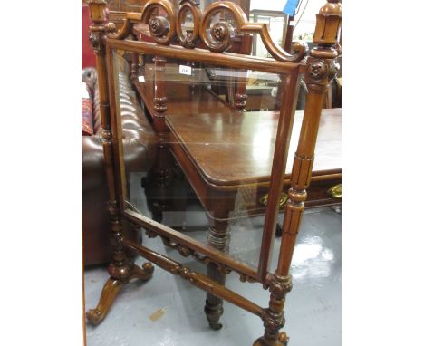 Victorian carved rosewood firescreen with glass panel raised on scroll feet 