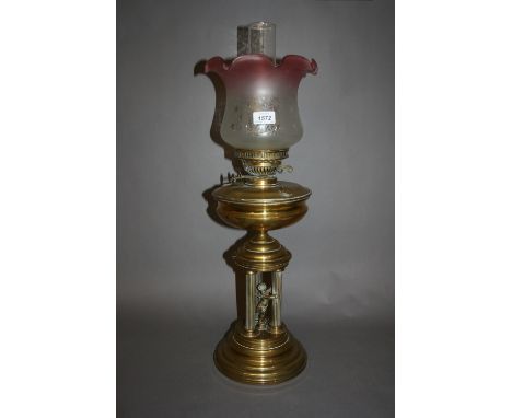 Edwardian brass oil lamp, the base in the form of a cherub and three columns with chimney and etched glass shade