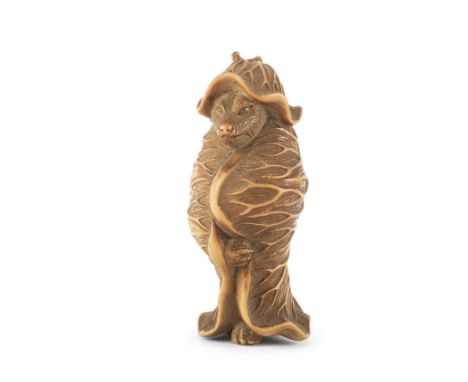 A pale boxwood netsuke of a badgerEdo period (1615-1868) or Meiji era (1868-1912), mid-late 19th centuryStanding and staring 