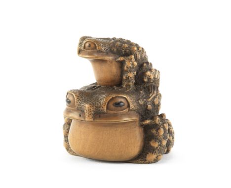 A wood netsuke of two toadsBy Masanao, Yamada, Ise Province, Edo period (1615-1868), 19th century A large toad seated in a ty
