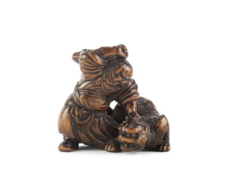 A wood netsuke of Hadesu slaying a tigerBy Tsuguhisa, Edo period (1615-1868), 19th centuryThe legendary warrior standing in a