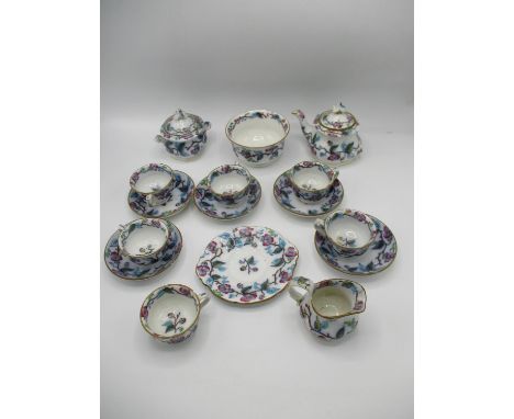 A Victorian dolls part teaset decorated with flowering vines, comprising of six cups, five saucers, a teapot, a lidded sugar,