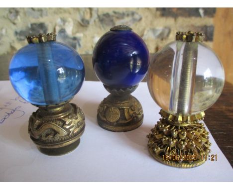 Three Chinese late 19th/early 20th century gilt metal and glass hat ranking finials, consisting of a third grade translucent 