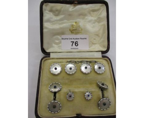 A platinum, mother of pearl and sapphire gentleman's part set of shirt studs and cuff-links in a leather box marked Clarke of