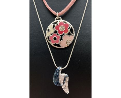2 silver necklaces. A modern design two tone illusion pendant set with small round cut diamonds. On an 18 inch fine snake cha