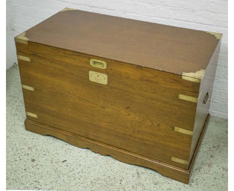 TRUNK, on stand, 19th century teak and brass bound with hinged top enclosing interior compartments with plaque inscribed Alex