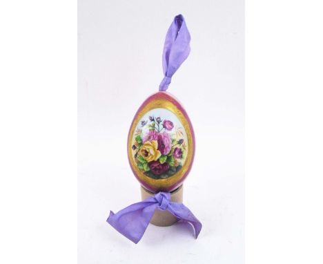 RUSSIAN CERAMIC PRESENTATION EASTER EGG, painted yellow and pink roses in a cartouche on a lilac ground, 11.5cm H.