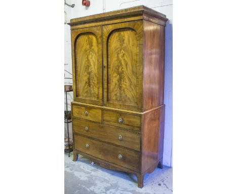 LINEN PRESS, 19th century mahogany with two arched panelled doors above enclosing shelves and two short and two long drawers 