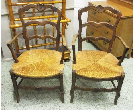 FARMHOUSE CHAIRS, a set of eight, early 20th century French oak with ladder backs and rush seats joined by stretchers, (8) (i