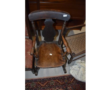 A 19t Century stained frame child's rocking chair having vase back