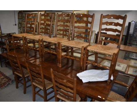 A set of ten (eight plus two) good quality reproduction ladder back chairs having rush seats