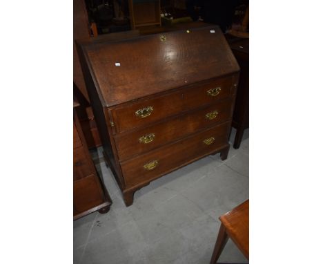 A Georgian oak bureau having semi fitted interior, three long drawers to base on bracket feet, possibly later handles, width 