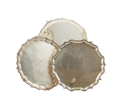 A modern salver R W Sorley, Glasgow 1915, of circular form with moulded rim raised on three bracket feet; together with two s