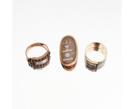 A collection of Georgian mourning jewellery to include a late 18th Century mourning brooch, the oval glazed panel with enamel