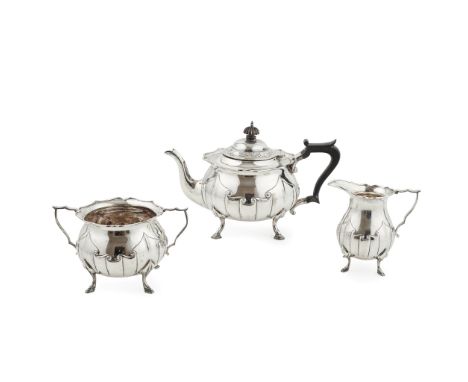 An Art Nouveau three piece tea service James Deakin &amp; Sons, Sheffield 1912, comprising a teapot, twin handled sugar basin