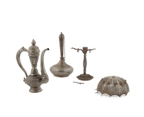 A Middle Eastern coffee pot unmarked, all over embossed decoration, the thin neck to a baluster body, the elongated spout, wi