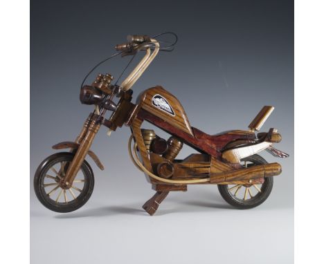 DESCRIPTION:A carved wooden model of a Harley Davidson motorcycle. CIRCA:20th Ct.ORIGIN:USADIMENSIONS:H:11.75" L:16.25" W:3.5