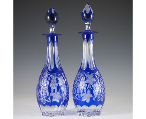 DESCRIPTION: Bohemian crystal decanters featuring a bulbous shape with a slim tapering neck and overal cobalt blue hue. Finis