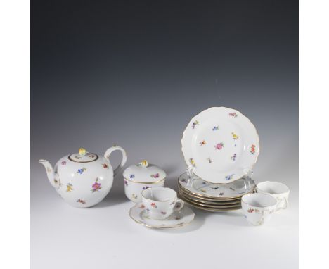 DESCRIPTION: A Meissen porcelain tea set. Features handpainted floral motif with multi-hued flower, and porcelain flower hand